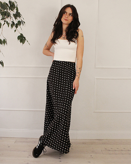 Black maxi skirt with a polka dot pattern in white