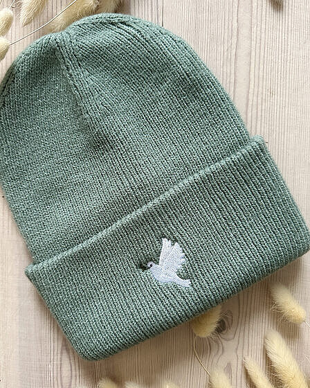 Sage green beanie embroidered with a peace dove