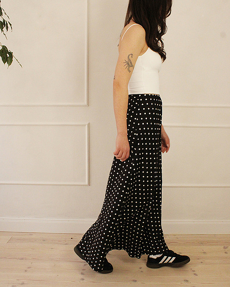 Black maxi skirt with a polka dot pattern in white