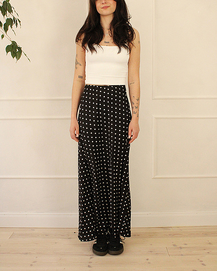 Black maxi skirt with a polka dot pattern in white